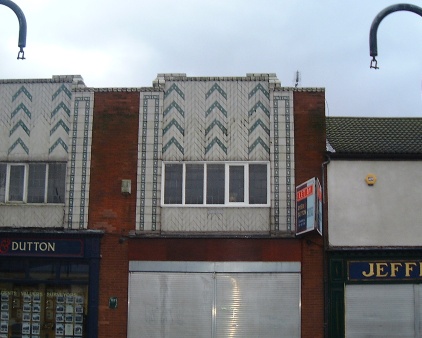 Detail of the tiles above
                    the shops on Manchester Road
